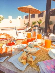 a picnic table with food and drinks on it at Riad des Lys in Marrakesh