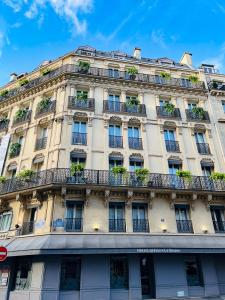 a tall building with balconies and plants on it at Hotel Litteraire Le Swann, BW Premier Collection in Paris