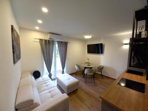 a living room with a white couch and a table at Ferma in Makarska