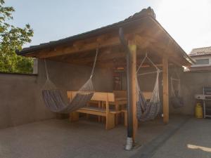 a patio with two hammocks under a canopy at Holiday Home Thesaurum in Karanac +17 photos