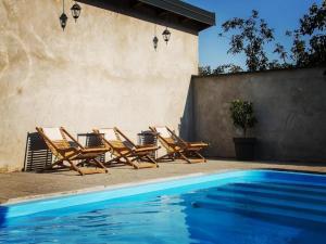 a group of chairs sitting next to a swimming pool at Holiday Home Thesaurum in Karanac