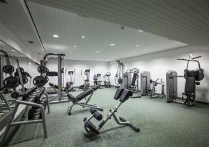 a gym with several exercise bikes and treadmills at Resort Hotel Alex Zermatt in Zermatt
