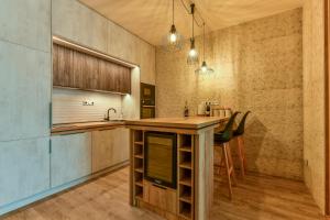 a kitchen with a wooden island in a room at Hotel Stračena City in Ostrava
