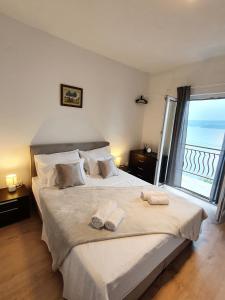a bedroom with a large bed with towels on it at Apartment ZaDoDa in Omiš