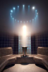 a bathroom with a urinal in a room with lights at Grand Hotel Amrâth Amsterdam in Amsterdam