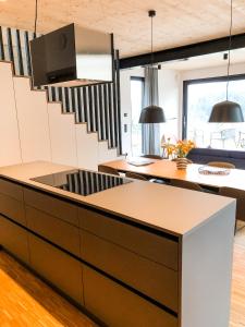 a kitchen with a staircase in a house at Sauerland Lodge - Haus Maxim in Winterberg