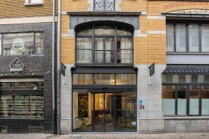 a store front of a brick building with windows at ALMA Grand Place Hotel in Brussels