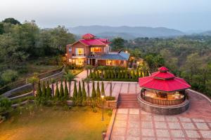 an aerial view of a house with a red roof at StayVista at Dhauladhar House - Aesthetic 4 BHK Villa in Kangra in Dharamshala