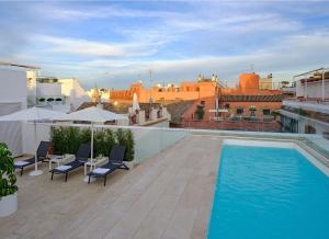 a swimming pool on the roof of a building at Hotel Rey Alfonso X in Seville