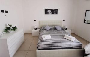 A bed or beds in a room at Casa Landolina Noto