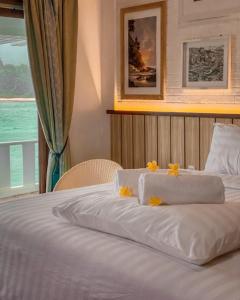 a bed with two towels on top of it at Morelo Water Villa in Batam Center