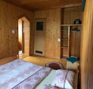 a bedroom with a bed in a wooden cabin at Złoty Kłos in Szklarska Poręba