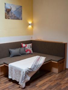 a room with a bed and a bench in it at Landhaus Volderau in Neustift im Stubaital