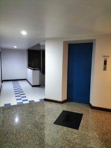 an empty room with a blue door in a building at Perfectroom Mansion in Hat Yai