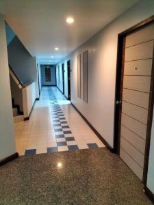 a hallway with a tile floor and a door at Perfectroom Mansion in Hat Yai