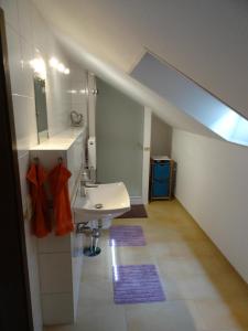a bathroom with a sink and a mirror and a sink at Fewo Lena in Welling