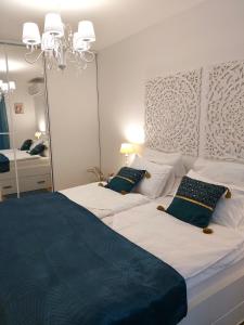 a bedroom with two beds and a large mirror at Apartments Fontana 20 in Budva