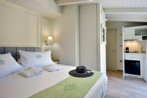 a bedroom with a bed with a hat on it at CASA VERDE in Corfu