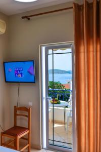a room with a sliding glass door leading to a balcony at Elidon Apartments in Sarandë