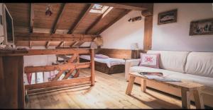 - un salon avec un canapé et des lits superposés dans l'établissement Coeur de montagne, à Gignod