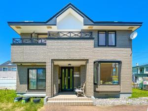 a house with a front door and windows at Crane in Kushiro