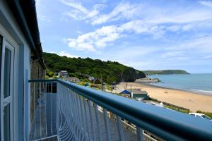 a balcony with a view of the beach at Ship Inn in Aberporth