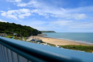 a balcony with a view of a beach and the ocean at Ship Inn in Aberporth
