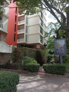 a building with a sign in front of it at Aster Residence in Chiang Mai