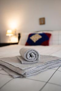 a towel sitting on top of a bed at Violetta's House Παραδοσιακή Βίλα στην Πορταριά in Portariá