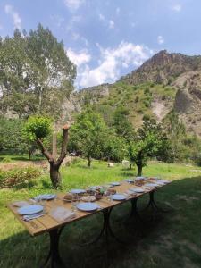 a long wooden table with food on top of a field at Old Jermuk 