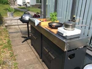 a outdoor kitchen with a counter with a stove at Nösund Guestroom in Nösund