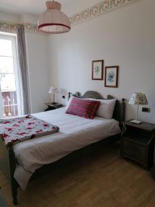 a bedroom with a bed and a window and a lamp at Appartamenti Val di Fassa Passo Costalunga 223, 119, 114 in Vigo di Fassa