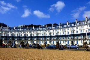 a large white building with a sign on it at Beautifully appointed, period seaside apartment in Folkestone