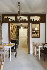 a kitchen and dining room with a table and chairs at Casa da Praça - Guest House in Pinhel