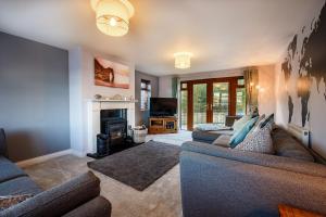 a living room with a couch and a fireplace at Beautiful Large 4 bedroom house with hot tub in West Coker