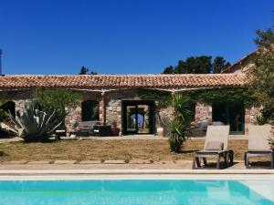 a house with a pool in front of it at La Masseria - Rainbow Hotel LGBT - Adults Only in Campofelice di Roccella