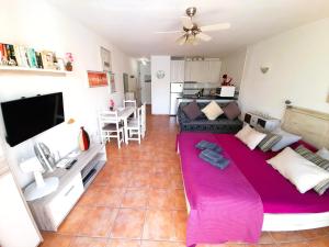 a living room with a large purple bed in a room at Mareverde Fase I in Adeje +6 photos