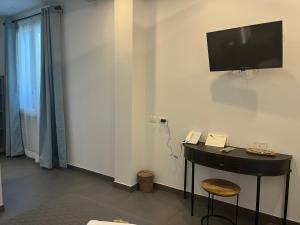 a room with a desk and a television on the wall at Hotel Il colle di Monterosso in Monterosso al Mare +46 photos