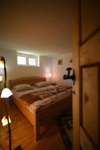 a bedroom with a bed and a lamp and a window at Cabarkapa Guesthouse in Žabljak