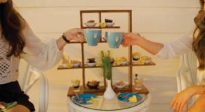 two women holding up blue cups on a table at Morelo Water Villa in Batam Center