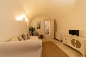 a living room with a couch and a tv at B&B Centro Storico in Otranto