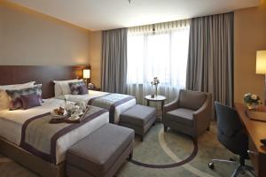 a hotel room with a bed and a desk and a chair at Crowne Plaza Istanbul Oryapark by IHG in Istanbul