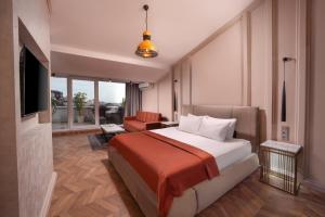a hotel room with a bed and a living room at Harbiye Residence in Istanbul