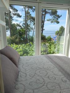 a bedroom with a bed in front of a window at HOSTAL FORMOSO in San Francisco
