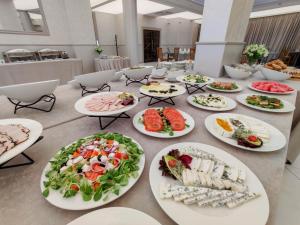 a long table with plates of food on it at Aneks Hotelu Kazimierz in Krakow