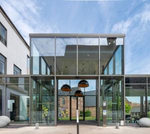 an office building with glass doors and windows at Martin's Klooster in Leuven