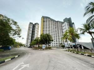 an empty street in front of a large building at Maya Apartment Bay View Villas in Port Dickson