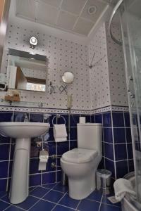 a bathroom with a toilet, sink, and bathtub at Blue House Hotel in Istanbul