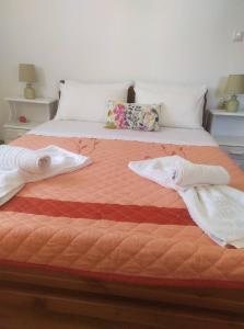 a bedroom with a bed with two towels on it at Eutyxia House in Gaios Walk to Center & Beaches in Gaios