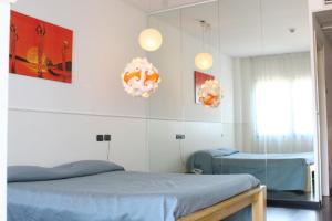 a hospital room with two beds and two lights at Orzihotel in Orzivecchi